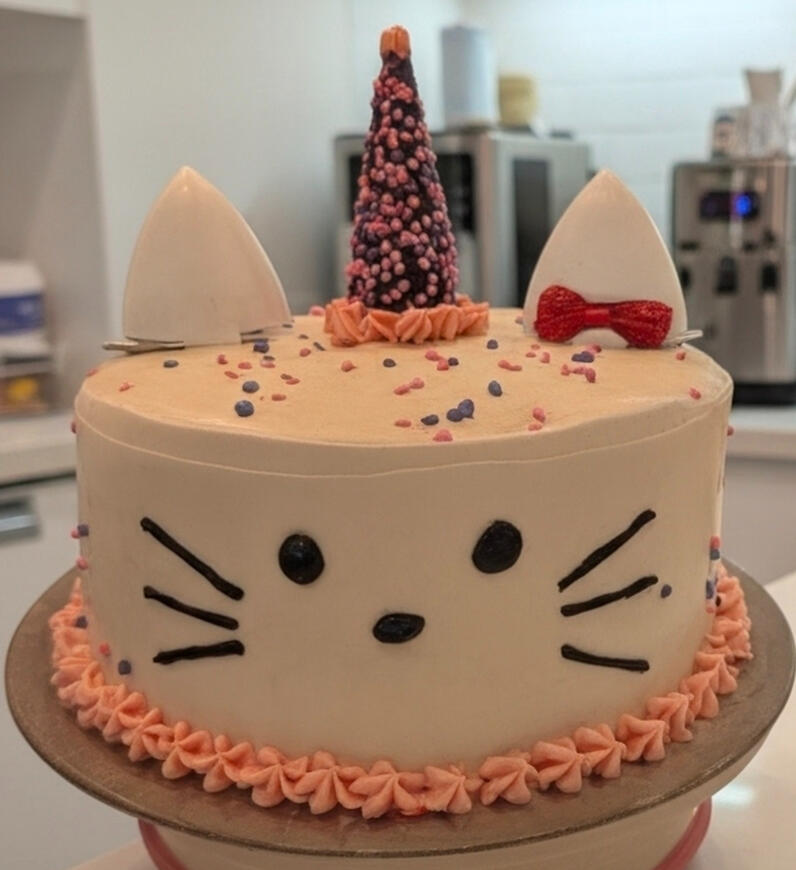 Custom kitty cat birthday cake Custom kitty cat birthday cake with ears, whiskers, and a red bow by Rylee's Sunrise Bakery