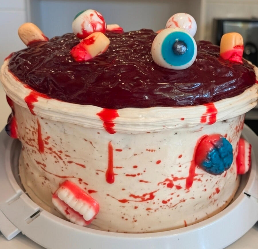 Spooky Halloween cake with candy eyeballs Spooky Halloween cake with red drip, candy eyeballs, and gummy teeth
